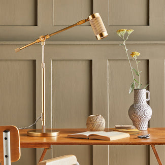 Stilt desk lamp in antiqued brass